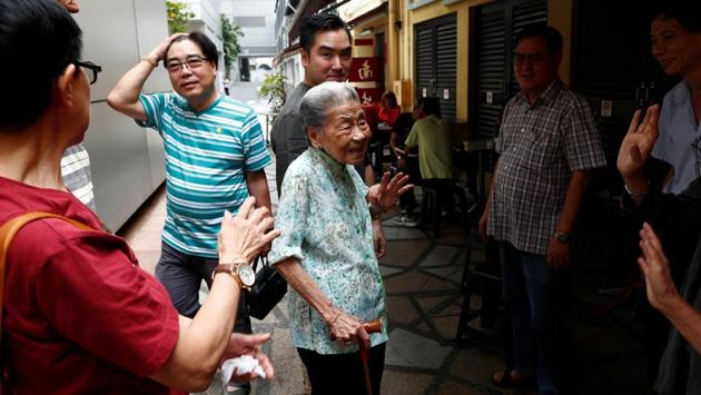 Leong Yuet Meng of Nam Seng Noodle House is greeted by longtime patrons and family friends outside her shop. “I don’t think hawker centres will exist in the next 50 years,” Lee said. “It’s too much hard work, we have to put in 16 hours a day sometimes. It’s hot. Kids nowadays wouldn’t want to work here.” (Edgar Su / REUTERS)