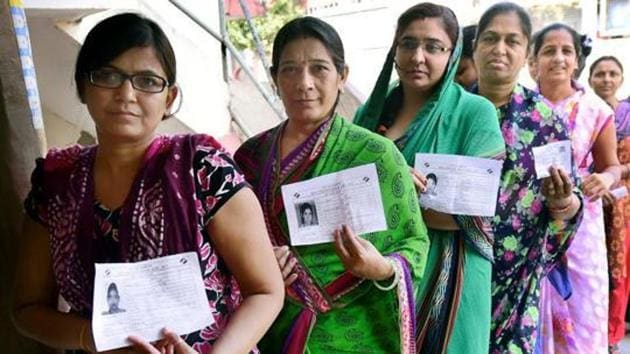 Voters wait to cast votes during an election in Daskroi constituency of Ahmedabad in 2017.(PTI file photo)