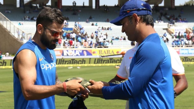 MS Dhoni presents a camouflage cap to Virat Kohli ahead of the Ranchi ODI against Australia.(Twitter/BCCI)