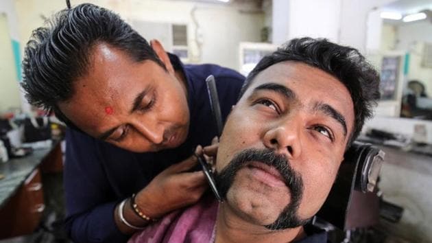 Dhiren Makvana gets his moustache trimmed similar to the one sported by Indian Air Force pilot Abhinandan Varthaman, who was captured and later released by Pakistan, inside a salon in Ahmedabad, Gujarat. (Amit Dave / REUTERS) Dhiren Makvana gets his moustache trimmed similar to the one sported by Indian Air Force pilot Abhinandan Varthaman, who was captured and later released by Pakistan, inside a salon in Ahmedabad, Gujarat. (Amit Dave / REUTERS)