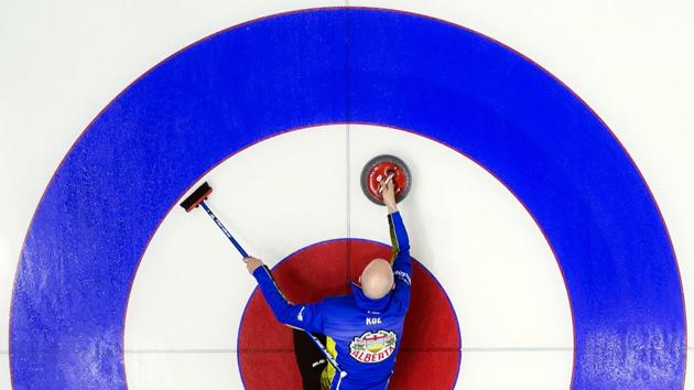Team Alberta skip Kevin Koe makes a shot during the 10th draw against team British Columbia at the Brier curling tournament in Brandon, Manitoba, Canada. (Jonathan Hayward / The Canadian Press via AP) 