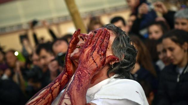 A “Momotxorro”' takes part in the carnival in Alsasua, northern Spain. During the carnival Momotxorros, characters who seem to have been resurrected from a prehistoric ritual, come out onto the streets wearing horns and hiding their faces under headscarves, and dressed in a white sheet stained with blood. (Alvaro Barrientos / AP) 