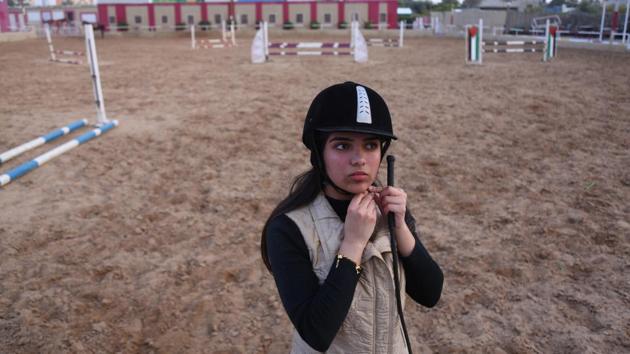 Fatma Youssef, 17, a high school student and a horse rider, adjusts her helmet as she prepares to ride a horse at an equestrian club, in Gaza City. “I’m nervous because this is my final high school year, but when I ride my horse I become free of stress,” Youssef said. (Samar Abo Elouf / REUTERS) Fatma Youssef, 17, a high school student and a horse rider, adjusts her helmet as she prepares to ride a horse at an equestrian club, in Gaza City. “I’m nervous because this is my final high school year, but when I ride my horse I become free of stress,” Youssef said. (Samar Abo Elouf / REUTERS)