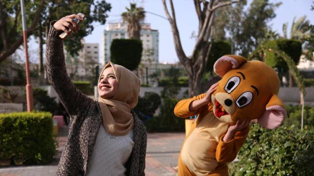 High school student Wessal Abu Amra, 17, takes a selfie at a public park. Abu Amra loves to go around Gaza with her friends, shopping and eating fast food. “We have things that look like famous brands but they are not the same,” she said. “Despite wars and the bad economy, we are trying to find some joy. We know the reality we live in so we do things we love to get out of a bad mood.” (Samar Abo Elouf / REUTERS) High school student Wessal Abu Amra, 17, takes a selfie at a public park. Abu Amra loves to go around Gaza with her friends, shopping and eating fast food. “We have things that look like famous brands but they are not the same,” she said. “Despite wars and the bad economy, we are trying to find some joy. We know the reality we live in so we do things we love to get out of a bad mood.” (Samar Abo Elouf / REUTERS)