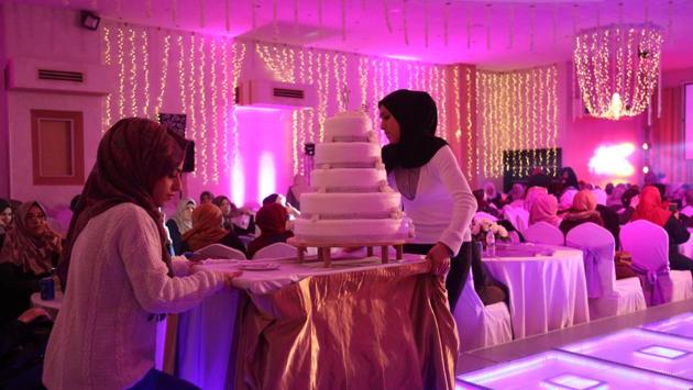 Sahar Yaghi (L), 28, prepares to serve cake during a wedding party at a hotel in Gaza City. Other Gaza women say community pressures weigh on them as they seek to bypass Gaza’s economic struggles by working jobs which some see as non-traditional. Yaghi, 28, took up work as a wedding planner soon after dropping out of university to earn income for her family. (Samar Abo Elouf / REUTERS) Sahar Yaghi (L), 28, prepares to serve cake during a wedding party at a hotel in Gaza City. Other Gaza women say community pressures weigh on them as they seek to bypass Gaza’s economic struggles by working jobs which some see as non-traditional. Yaghi, 28, took up work as a wedding planner soon after dropping out of university to earn income for her family. (Samar Abo Elouf / REUTERS)