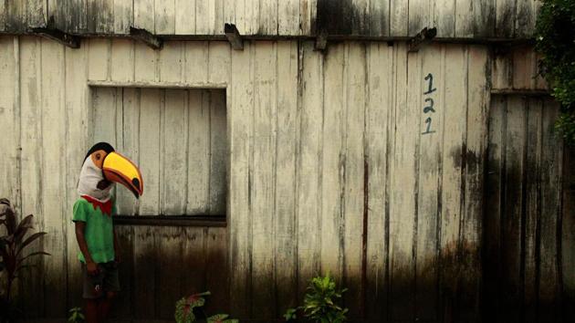 A carnival reveler in a bird costume pauses in front of a traditional Amazonian home during the “Cordao da Bicharada” celebration in Cameta, Para state, Brazil. Carnival in Cameta celebrates the forest, putting its animals at the forefront as an ecological manifest in defense of the protection of their forests. (Raimundo Pacco / AP) 