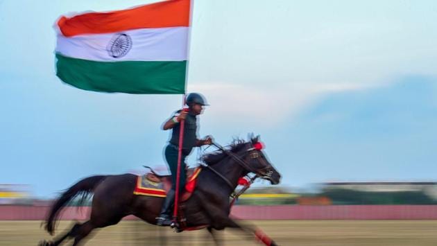 An army personnel holding the tricolour displays his horse-riding skills during the combined display of martial arts and combat skills by the cadets at Officers Training Academy in Chennai, Tamil Nadu. (PTI) An army personnel holding the tricolour displays his horse-riding skills during the combined display of martial arts and combat skills by the cadets at Officers Training Academy in Chennai, Tamil Nadu. (PTI)