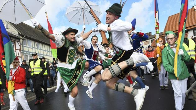 Performers jump on the street during a carnival parade in Herbstein, Germany. (Uwe Zucchi / dpa via AP) 