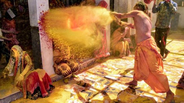 Devotees play Holi at Ghanshyam Ji Temple ahead of the festival, in Jodhpur, Rajasthan. (PTI) Devotees play Holi at Ghanshyam Ji Temple ahead of the festival, in Jodhpur, Rajasthan. (PTI)