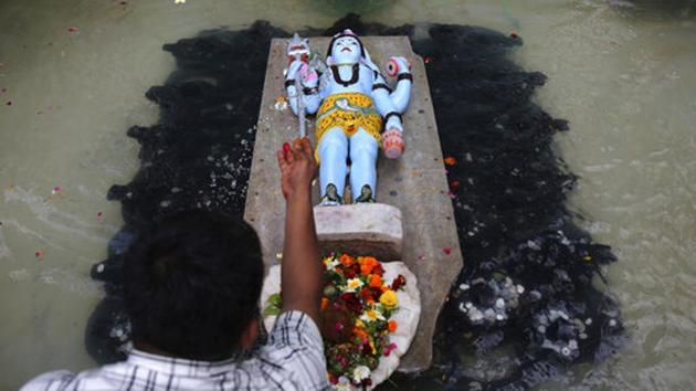 A devotee prays to a statue of Lord Shiva at a temple on the occasion of Maha Shivratri festival in Mumbai, Maharashtra. (Rafiq Maqbool / AP) A devotee prays to a statue of Lord Shiva at a temple on the occasion of Maha Shivratri festival in Mumbai, Maharashtra. (Rafiq Maqbool / AP)
