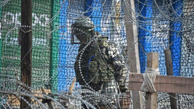 A paramilitary trooper stands guard behind a barbed fence wire outside a bunker during a one-day strike called by Kashmiri traders against the Jamaat-e-Islami ban, in Srinagar, Jammu and Kashmir. (Tauseef Mustafa / AFP) A paramilitary trooper stands guard behind a barbed fence wire outside a bunker during a one-day strike called by Kashmiri traders against the Jamaat-e-Islami ban, in Srinagar, Jammu and Kashmir. (Tauseef Mustafa / AFP)