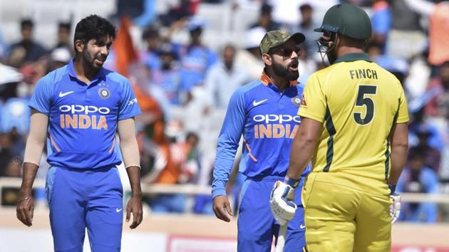 Kohli has a heated exchange with Australia's skipper Aaron Finch as Jasprit Bumrah looks on. (PTI) Kohli has a heated exchange with Australia's skipper Aaron Finch as Jasprit Bumrah looks on. (PTI)