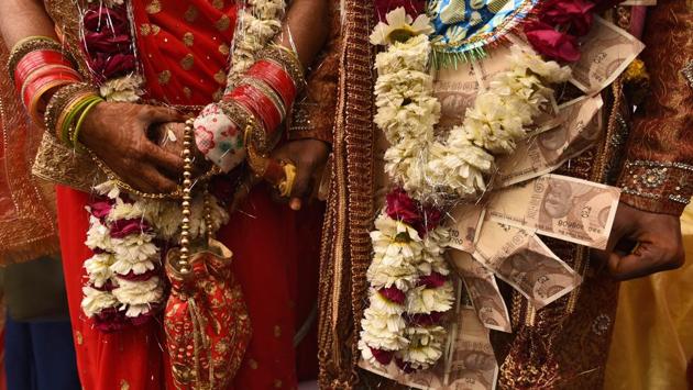 A groom and bride stand after performing rituals during a mass wedding for eight couples at Hanuman Vatika Ramleela Maidan, in New Delhi. (Burhaan Kinu / HT Photo) A groom and bride stand after performing rituals during a mass wedding for eight couples at Hanuman Vatika Ramleela Maidan, in New Delhi. (Burhaan Kinu / HT Photo)