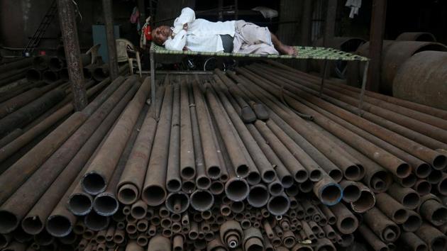 A man sleeps on a bed amid metal rods in Mumbai, Maharashtra. (Francis Mascarenhas / REUTERS) A man sleeps on a bed amid metal rods in Mumbai, Maharashtra. (Francis Mascarenhas / REUTERS)