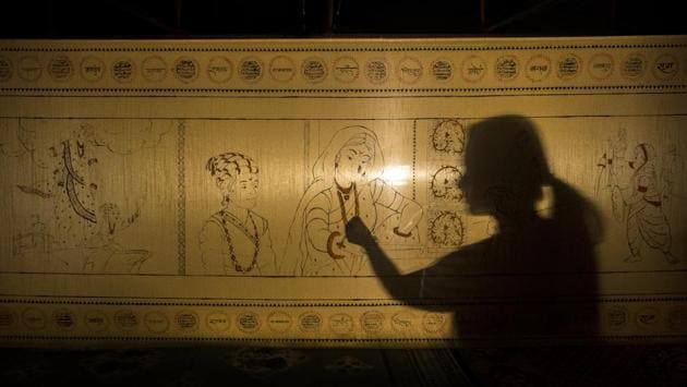 Artist Shrutika Ghag gives final touches to a saree which has an autobiographic representation of Rajmata Jijau's life and it is 125 feet long and hand painted with three colours. (Pratik Chorge / HT Photo) Artist Shrutika Ghag gives final touches to a saree which has an autobiographic representation of Rajmata Jijau's life and it is 125 feet long and hand painted with three colours. (Pratik Chorge / HT Photo)