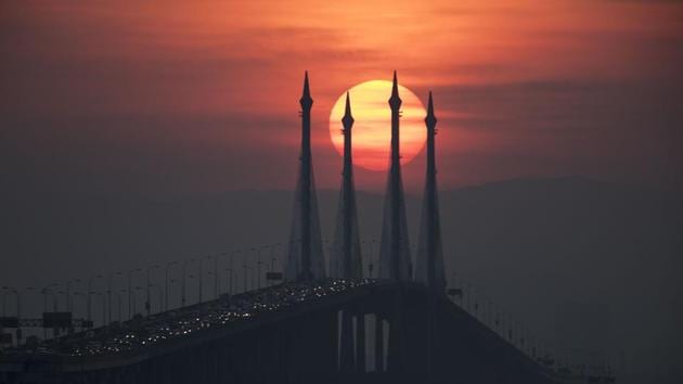 The sun rises over the Penang bridge in Penang island, Northern Malaysia. (Vincent Thian / AP) 