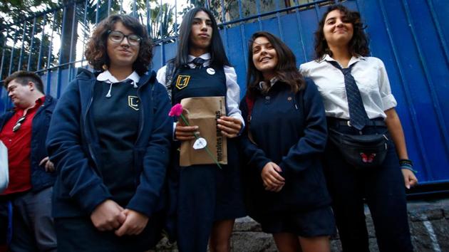 Chilean transgender student Arlen Aliaga (2-L) poses with classmates at a girl’s public high school in Santiago, Chile. Arlen, 18, started classes at a school for girls Monday, after giving a tough fight to be admitted. (Pablo Vera / AFP) 