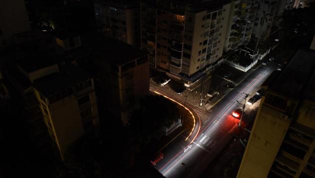 Light trails left by moving traffic are seen in darkness during a continued power outage in the Los Palos Grandes neighbourhood of Caracas. The blackout came amid a weeks-long struggle for control, with Washington backing opposition leader Juan Guaido’s bid to unseat the autocratic President Nicolas Maduro. Hours after the country went dark Thursday, the Maduro camp sought to hold Washington responsible, accusing the U.S. of sabotaging the grid. (Carlos Becerra / Bloomberg) Light trails left by moving traffic are seen in darkness during a continued power outage in the Los Palos Grandes neighbourhood of Caracas. The blackout came amid a weeks-long struggle for control, with Washington backing opposition leader Juan Guaido’s bid to unseat the autocratic President Nicolas Maduro. Hours after the country went dark Thursday, the Maduro camp sought to hold Washington responsible, accusing the U.S. of sabotaging the grid. (Carlos Becerra / Bloomberg)