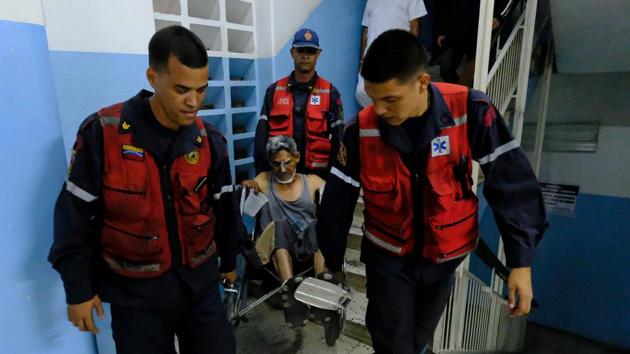 An injured man is carried by paramedics inside Miguel Perez Carreno hospital, in Caracas. The outage had left most of the country in disarray, crippling day-to-day functioning of hospitals and other public services. Witnesses described scenes of chaos at several hospitals as people tried to move sick relatives in the dark to clinics with better emergency power facilities. (Matias Delacroix / AFP) An injured man is carried by paramedics inside Miguel Perez Carreno hospital, in Caracas. The outage had left most of the country in disarray, crippling day-to-day functioning of hospitals and other public services. Witnesses described scenes of chaos at several hospitals as people tried to move sick relatives in the dark to clinics with better emergency power facilities. (Matias Delacroix / AFP)