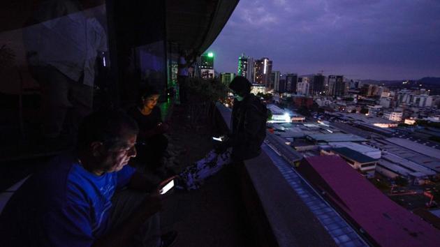 Journalists use their smartphones during a power cut in Caracas. Venezuela’s worst power and communications outage on Friday deepened a sense of isolation and decay, endangering hospital patients, forcing schools and businesses to close and cutting people off from their families, friends and the outside world.While electricity returned to some parts of Caracas nearly 24 hours after lights, phones and the internet stopped working, several other populous cities remained in the dark as evening approached. (Matias Delacroix / AFP) Journalists use their smartphones during a power cut in Caracas. Venezuela’s worst power and communications outage on Friday deepened a sense of isolation and decay, endangering hospital patients, forcing schools and businesses to close and cutting people off from their families, friends and the outside world.While electricity returned to some parts of Caracas nearly 24 hours after lights, phones and the internet stopped working, several other populous cities remained in the dark as evening approached. (Matias Delacroix / AFP)