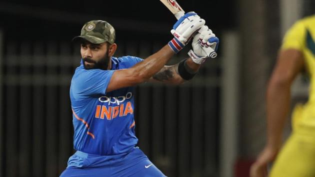 India's captain Virat Kohli, left, bats during the third one day international cricket match between India and Australia in Ranchi.(AP)