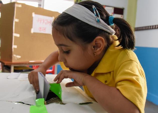 A student is seen casting her vote,  in the mock elections of Abhinav pre primary school. (Sanket Wankhade/HT PHOTO) 