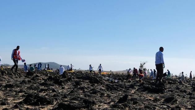 Rescue workers at the scene of the Ethiopian Airlines plane crash southeast of Addis Ababa on Sunday in which four Indians were among those killed. (REUTERS) Rescue workers at the scene of the Ethiopian Airlines plane crash southeast of Addis Ababa on Sunday in which four Indians were among those killed. (REUTERS)