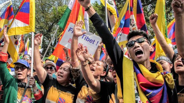 Tibetans shout slogans on the second day of their march from Khan Market to United Nations House to mark the 60th anniversary of the 1959 Tibetan uprising against Chinese rule, in New Delhi. (PTI Photo)