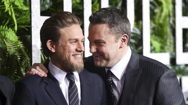 Actors Charlie Hunnam, left, and Ben Affleck share a laugh at the world premiere of Triple Frontier at Jazz at Lincoln Center.(Evan Agostini/Invision/AP)