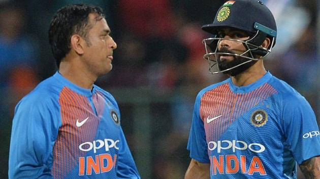 Virat Kohli (R) and MS Dhoni walk together during the second T20 international match between India and Australia.(AFP)