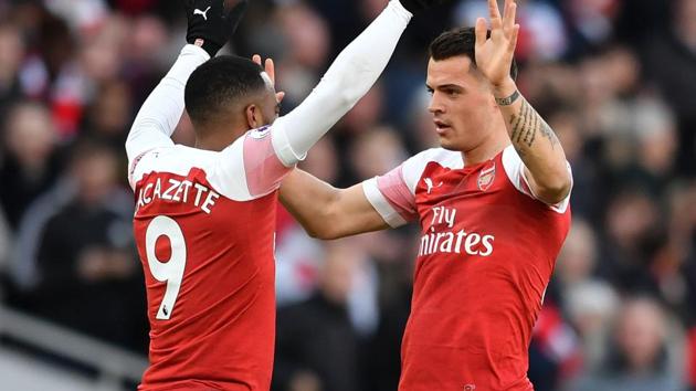 Arsenal's Swiss midfielder Granit Xhaka (R) celebrates scoring the opening goal with Arsenal's French striker Alexandre Lacazette during their Premier League match against Manchester United.(AFP)