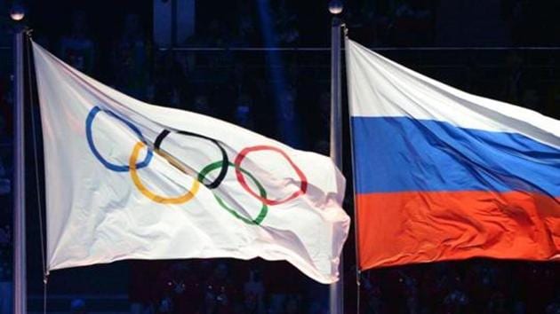 Olympic and Russian flags being hoisted during the Opening Ceremony of the Sochi Winter Olympics.(AFP)