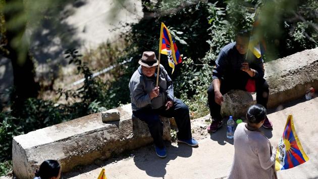 Devotees in the Indian hill station the Dalai Lama has called home for six decades waved Tibet’s colourful “snow lion” flag, which China has outlawed as a symbol of separatism. Some had “Free Tibet” painted on their faces along with the colours and distinct golden sun of the iconic flag. “This is a proud day,” Lhakpa Tsering, a Tibetan living in exile in India, told AFP in Dharamsala. (Money Sharma / AFP) 