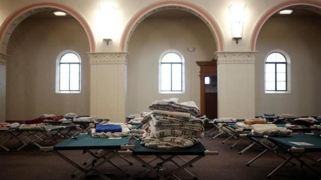 Red Cross blankets and cots fill the chapel of a monastery in preparation for large groups of migrants in Tucson. In January, Catholic Community Services (CCS) turned to the American Red Cross for cots and blankets to equip the former Benedictine monastery in Tucson, Arizona, as a shelter, said CCS Director of Operations Teresa Cavendish. (Nicole Neri / REUTERS)