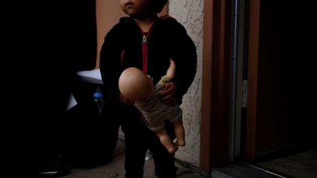 A young migrant holds a doll she arrived with at a motel in Tucson, Arizona, United States. A motel and a monastery are among several pop-up shelters that have opened in the last six months in Arizona to house a rising number of migrants from Central America entering the United States to seek asylum. (Nicole Neri / REUTERS)