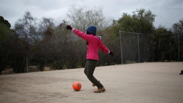 A young migrant plays with a ball at a monastery. US Border Patrol officials told Reuters that there has been a dramatic shift in how migration is happening along the US-Mexico border, with large numbers of families and unaccompanied children from the northern triangle countries of Guatemala, Honduras and El Salvador replacing mostly single adult men from Mexico who typically crossed the border illegally in the past. (Nicole Neri / REUTERS)