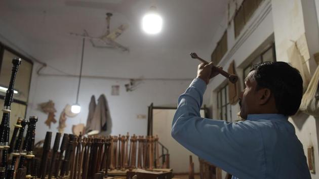 A worker inspects a component. South Asia has had for centuries its pungi, a wind instrument used for snake charming, and shehnai, a traditional oboe. But the bagpipe had to wait until the mid-19th century for British colonialists to bring it to subcontinental India, of which Pakistan was a part before independence and partition in 1947. (Aamir Qureshi / AFP) 
