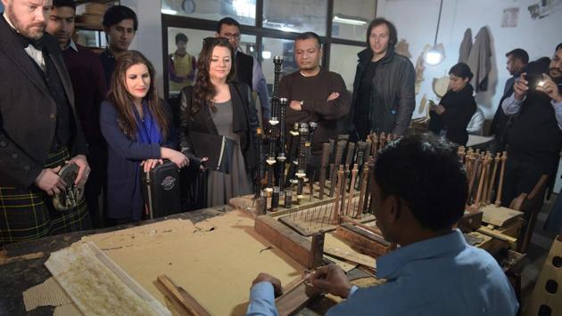Visiting international musicians watch the manufacturing process at the Mid East bagpipe factory. Cheap labour means Pakistani bagpipes are priced less expensively than ones made in Scotland. But Pakistani bagpipes have a reputation. “The quality of sound is not the same,” said Paul Gardner, manager of a London music store. “It might get somebody started, but that person will quickly look to upgrade.” (Aamir Qureshi / AFP) 