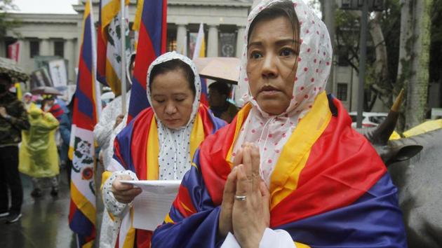 A Tibetan living in Taiwan prays during a similar rally in Taipei. Buddhist Tibet declared independence from China in the early 20th century but Beijing took back control in 1951, having sent in thousands of troops. The Dalai Lama -- chosen at the age of two in 1937 as the 14th incarnation of Tibetan Buddhism’s supreme leader -- was enthroned as head of state after the Chinese invasion. (Chiang Ying-ying / AP) 