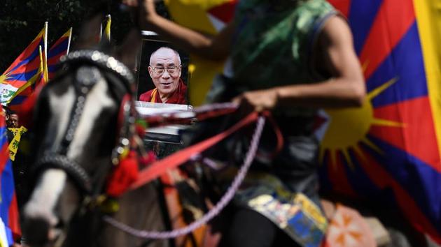 The Dalai Lama himself was not present at the anniversary ceremony, but chief representatives of the exiled Tibetan administration and foreign dignitaries gathered for the solemn occasion. Performers dressed in traditional attire danced and recited Tibetan songs at the temple for guests, which organisers said included parliamentarians from 10 nations. (Sajjad Hussain / AFP) 