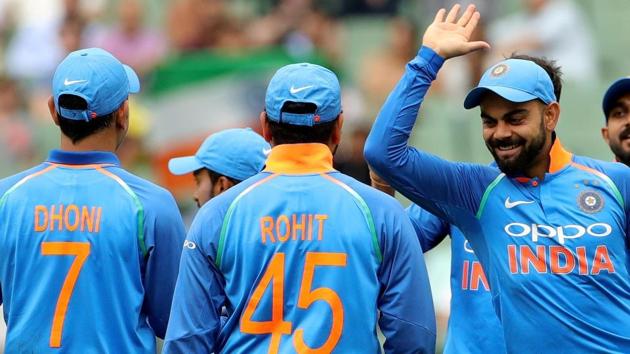 India's captain Virat Kohli celebrates with his teammates after the dismissal of Australia's Aaron Finch off the bowling of Bhuvneshwar Kumar during the third one-day international match between Australia and India at the MCG in Melbourne.(REUTERS)