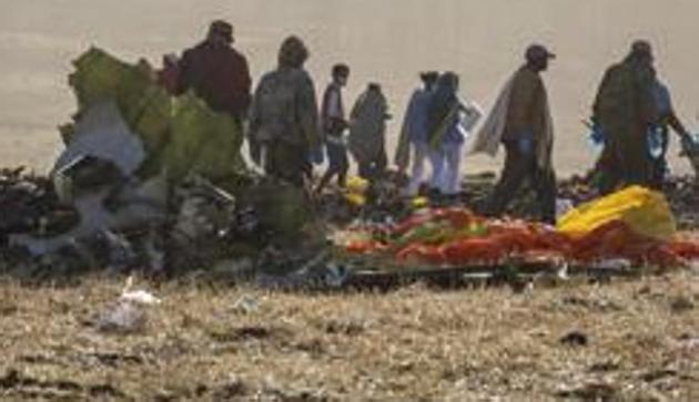 Rescuers work at the scene of an Ethiopian Airlines flight crash near Bishoftu, or Debre Zeit, south of Addis Ababa, Ethiopia, Monday, March 11, 2019. A spokesman says Ethiopian Airlines has grounded all its Boeing 737 Max 8 aircraft as a safety precaution, following the crash of one of its planes in which 157 people were killed. (AP Photo/Mulugeta Ayene)(AP)