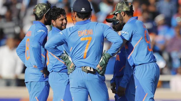 Kuldeep Yadav, second left, celebrates with teammates the dismissal of Australia's Peter Handscomb.(AP)