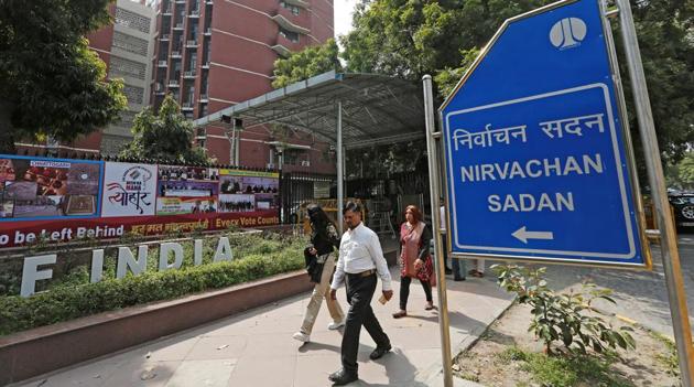People walk past the Election Commission of India office building in New Delhi on March 11. (REUTERS) People walk past the Election Commission of India office building in New Delhi on March 11. (REUTERS)