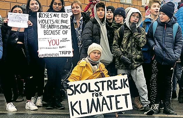 Greta Thunberg (yellow jacket) at a protest next to Sweden’s Parliament in Stockholm on March 8, 2019.(Reuters)