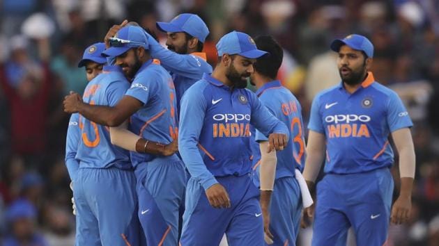 India's captain Virat Kohli, center, looks at his watch as his teammates celebrate the dismissal of Australia's Shaun Marsh during the fourth one day international cricket match between India and Australia in Mohali(AP)