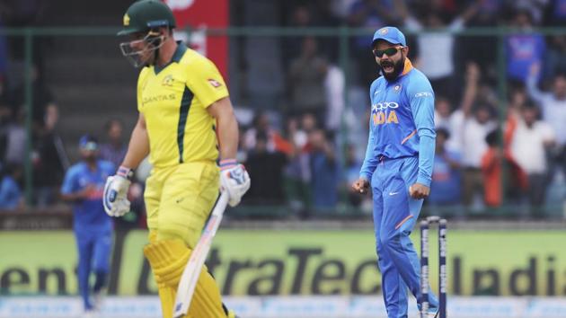 Indian cricket captain Virat Kohli, right, reacts after Australia's captain Aaron Finch, left, is dismissed. (AP)