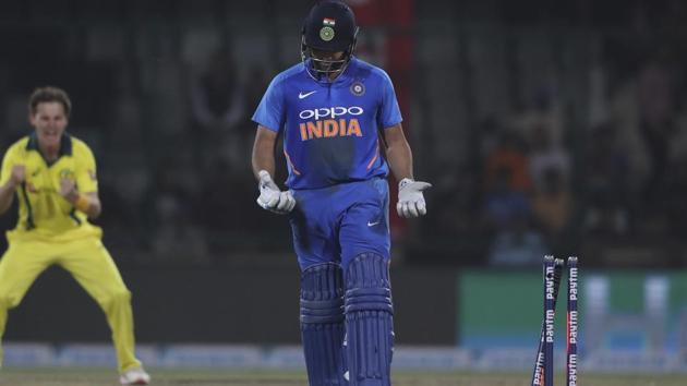 Rohit Sharma looks at his hands after his bat slipped and he was stumped out.(AP)
