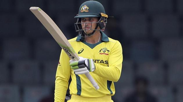 Australian cricketer Usman Khawaja raises his bat to celebrate scoring fifty runs. (AP)