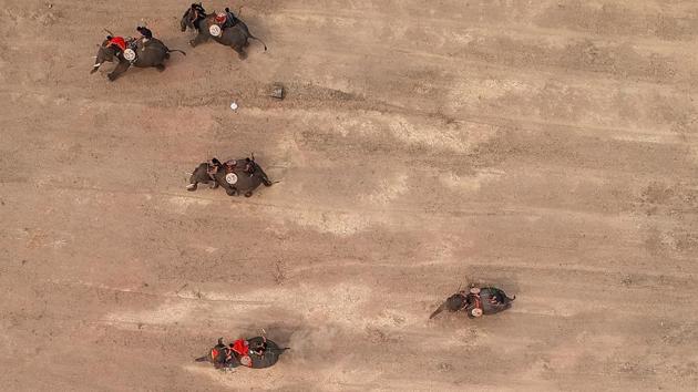 An aerial photo shows mahouts racing their elephants during the Buon Don elephant festival in Vietnam’s central highlands of Dak Lak province. Among them was mahout Y Hoi Bya, sat atop his elephant, whacking him with a large stick to urge him toward the finish line. (Manan Vatsyayana / AFP) An aerial photo shows mahouts racing their elephants during the Buon Don elephant festival in Vietnam’s central highlands of Dak Lak province. Among them was mahout Y Hoi Bya, sat atop his elephant, whacking him with a large stick to urge him toward the finish line. (Manan Vatsyayana / AFP)
